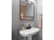 Stylish powder room with a modern sink, mirror, and decorative accents at 2303 Waters Edge Trl, Roswell, GA 30075