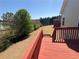 A view of a large grassy backyard and mature trees from a wooden deck at 3426 Olivia Grace Way, Dacula, GA 30019