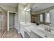 Bathroom featuring double sink vanity, framed mirror, tile flooring and glass shower at 3426 Olivia Grace Way, Dacula, GA 30019