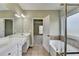 Bathroom featuring double vanity sinks, soaking tub and tile floor at 3426 Olivia Grace Way, Dacula, GA 30019