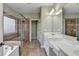 Bathroom featuring a tiled shower with glass door, double sinks, and tile flooring at 3426 Olivia Grace Way, Dacula, GA 30019