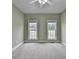 The bedroom has neutral carpet, two windows, and a ceiling fan at 3426 Olivia Grace Way, Dacula, GA 30019