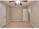 Bedroom with neutral carpet, ceiling fan, and white door to a hallway at 3426 Olivia Grace Way, Dacula, GA 30019