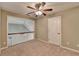 Bedroom with neutral carpet, ceiling fan, staircase, and a white door at 3426 Olivia Grace Way, Dacula, GA 30019