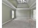 Large primary bedroom featuring a tray ceiling, neutral carpeting, and two large windows at 3426 Olivia Grace Way, Dacula, GA 30019