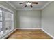 Bedroom featuring hardwood floors, neutral walls, and a ceiling fan for added comfort at 3426 Olivia Grace Way, Dacula, GA 30019
