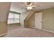 Carpeted bedroom with angled walls and neutral decor at 3426 Olivia Grace Way, Dacula, GA 30019
