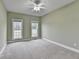 Spacious bedroom with neutral carpet, two windows, and a ceiling fan at 3426 Olivia Grace Way, Dacula, GA 30019