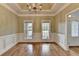 Dining room with hardwood floors, a tray ceiling, decorative trim, and views to the front yard at 3426 Olivia Grace Way, Dacula, GA 30019