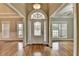 Elegant foyer with hardwood floors and a decorative glass front door, creating a welcoming entrance at 3426 Olivia Grace Way, Dacula, GA 30019