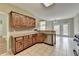 Open kitchen with stainless steel dishwasher, wood cabinets, and tile flooring at 3426 Olivia Grace Way, Dacula, GA 30019