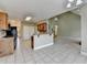 Open-concept kitchen with breakfast bar overlooking a living space and staircase at 3426 Olivia Grace Way, Dacula, GA 30019