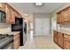 The kitchen features stainless steel appliances, tile floors, and wooden cabinets at 3426 Olivia Grace Way, Dacula, GA 30019