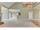 A bright living room with an open floor plan leads to the kitchen and has vaulted ceilings at 3426 Olivia Grace Way, Dacula, GA 30019