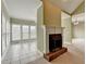 Living room with a fireplace and view to the sunroom with large windows at 3426 Olivia Grace Way, Dacula, GA 30019