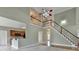 Living room with a grand staircase and views to the kitchen at 3426 Olivia Grace Way, Dacula, GA 30019