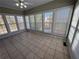 Bright sunroom featuring tile floors and multiple windows offering panoramic views at 3426 Olivia Grace Way, Dacula, GA 30019