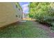 View of backyard with a well-maintained lawn, privacy fence, and a small patio area, perfect for outdoor relaxation at 6285 Polar Fox Ct, Riverdale, GA 30296