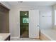 Bathroom with an open door reveals a glimpse of the bedroom, complemented by a large soaking tub at 6285 Polar Fox Ct, Riverdale, GA 30296