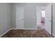 This bedroom features neutral paint and carpet floors, with a door to the side at 6285 Polar Fox Ct, Riverdale, GA 30296