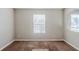 Neutral-colored bedroom with a large window and carpet at 6285 Polar Fox Ct, Riverdale, GA 30296