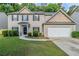Charming two-story home with a well-maintained lawn and attached two-car garage at 6285 Polar Fox Ct, Riverdale, GA 30296