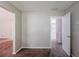 Hallway with fresh paint and neutral carpet transitions smoothly between rooms, offering easy access at 6285 Polar Fox Ct, Riverdale, GA 30296