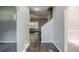 Bright hallway with wood floors leading to a living area with a ceiling fan at 6285 Polar Fox Ct, Riverdale, GA 30296
