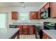 This kitchen has wood cabinets, modern appliances, and granite countertops at 6285 Polar Fox Ct, Riverdale, GA 30296