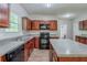 The kitchen features beautiful wood cabinets, a breakfast bar island, and modern appliances at 6285 Polar Fox Ct, Riverdale, GA 30296