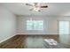 Large living room featuring hardwood-style floors, a window, and a sliding glass door at 6285 Polar Fox Ct, Riverdale, GA 30296