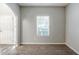 Neutral living room with plush carpeting and a window at 6285 Polar Fox Ct, Riverdale, GA 30296