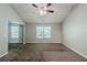 Spacious living room bathed in natural light features a ceiling fan and neutral-toned carpeting at 6285 Polar Fox Ct, Riverdale, GA 30296