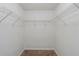 Empty walk-in closet with plenty of shelving and neutral carpet is ready to be organized at 6285 Polar Fox Ct, Riverdale, GA 30296