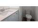 A clean bathroom with a white quartz countertop and a modern toilet at 101 Pearl St, Woodstock, GA 30188