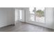 Bright bedroom with large windows, hardwood floors and a closet at 101 Pearl St, Woodstock, GA 30188