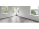 Bright bedroom featuring hardwood floors and three large windows at 101 Pearl St, Woodstock, GA 30188
