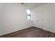 Bedroom with light gray wood floors, natural light, and a closet with bifold doors at 101 Pearl St, Woodstock, GA 30188