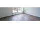 Bright, empty bedroom with natural light showcasing the hardwood floors at 101 Pearl St, Woodstock, GA 30188