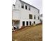 White townhouse exterior featuring a garage, a driveway and modern windows at 101 Pearl St, Woodstock, GA 30188