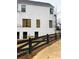 Townhouse with black metal fence, modern windows and newly installed mulch at 101 Pearl St, Woodstock, GA 30188