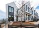 Townhouses with modern farmhouse style, black trim, and black metal fencing at 101 Pearl St, Woodstock, GA 30188