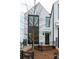 Modern home with a unique facade, complemented by minimalist landscaping and a sleek fence at 101 Pearl St, Woodstock, GA 30188