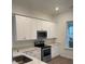 A kitchen featuring modern white cabinets, stainless steel appliances, and light countertops at 101 Pearl St, Woodstock, GA 30188
