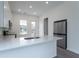 Well-lit kitchen with stainless steel appliances and quartz countertops, perfect for cooking at 101 Pearl St, Woodstock, GA 30188