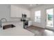 Bright kitchen features stainless steel appliances, white cabinets, and quartz countertops at 101 Pearl St, Woodstock, GA 30188