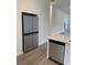 Modern stainless steel refrigerator and dishwasher in kitchen at 101 Pearl St, Woodstock, GA 30188