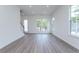 Spacious living area featuring natural light, hardwood floors, and access to the outdoors at 101 Pearl St, Woodstock, GA 30188