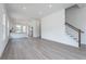 Open-concept living space with hardwood floors, flowing into a modern kitchen area at 101 Pearl St, Woodstock, GA 30188