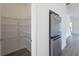Spacious pantry with abundant shelving and a view of the stainless steel refrigerator at 101 Pearl St, Woodstock, GA 30188